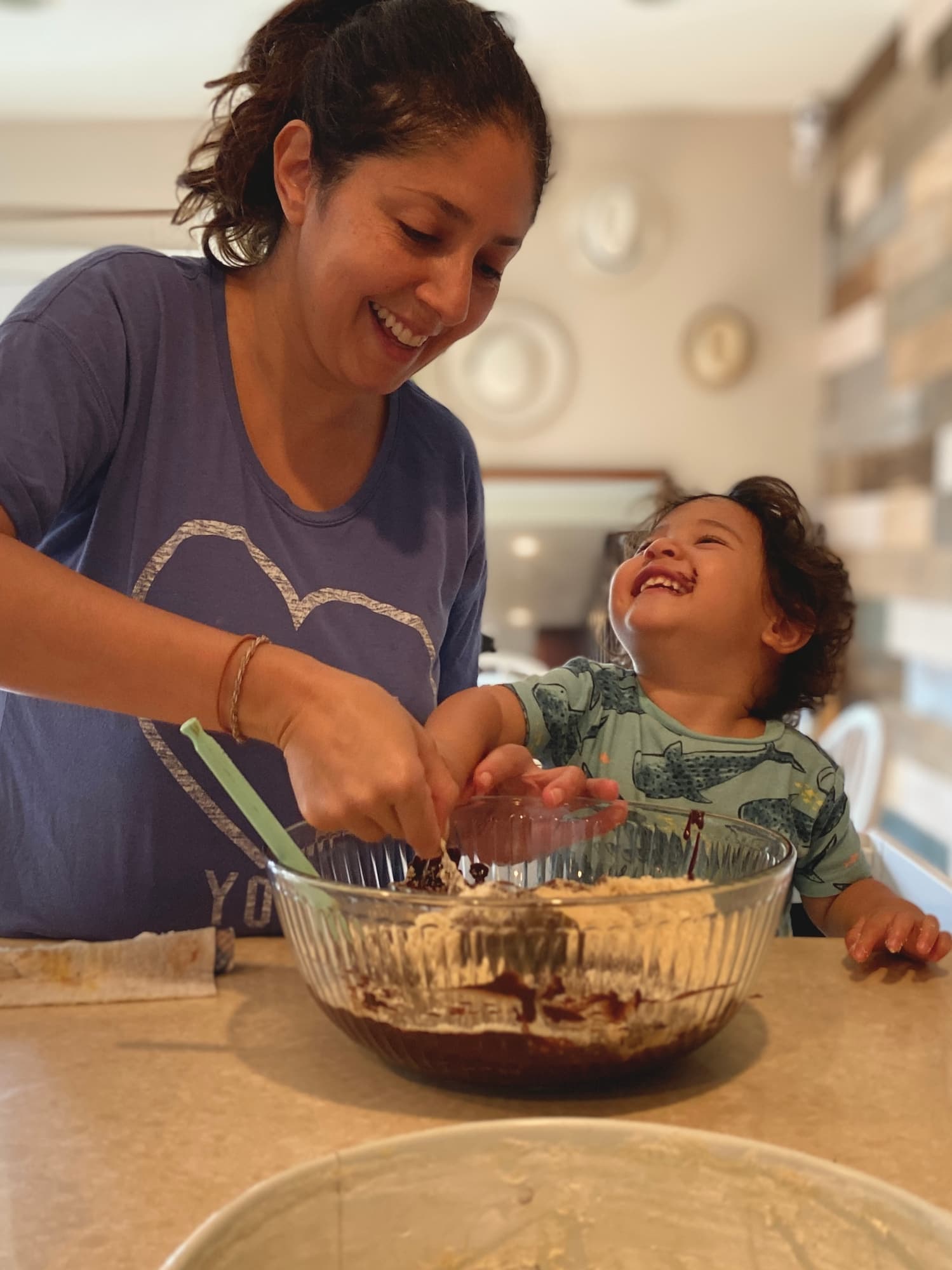 Maribel baking in the kitchen with her laughing toddler